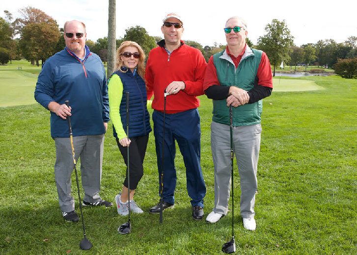 Four people on a golf course